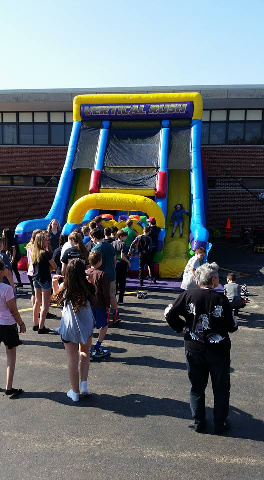 Vertical Rush inflatable slide with large student crowd at school carnival